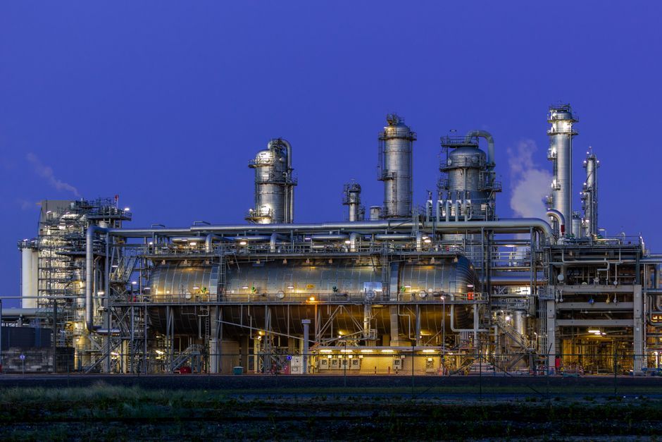Industrial refinery facility illuminated at dusk